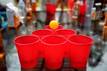 Large red drinking cups set up in a triangle shape