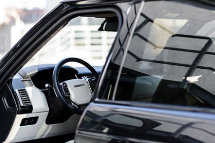 A modern, futuristic car with sleek white interior