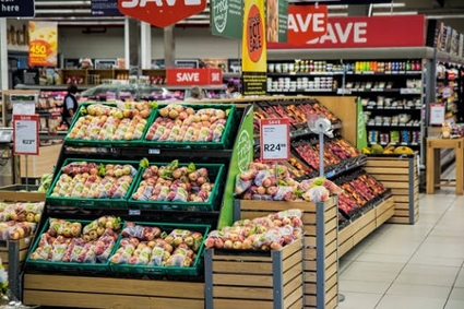 Supermarket produce section with a variety of colorful fruits on display