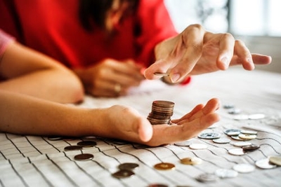 A person counting coins