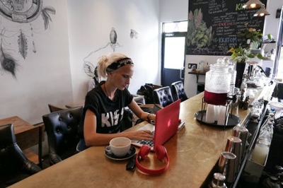 A girl working on her laptop in a cafe
