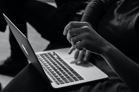 Monochrome of a person working on a laptop